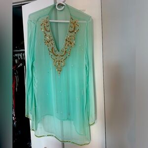 Long sleeve sheer top with pearls on it forming flowers, gold sequined